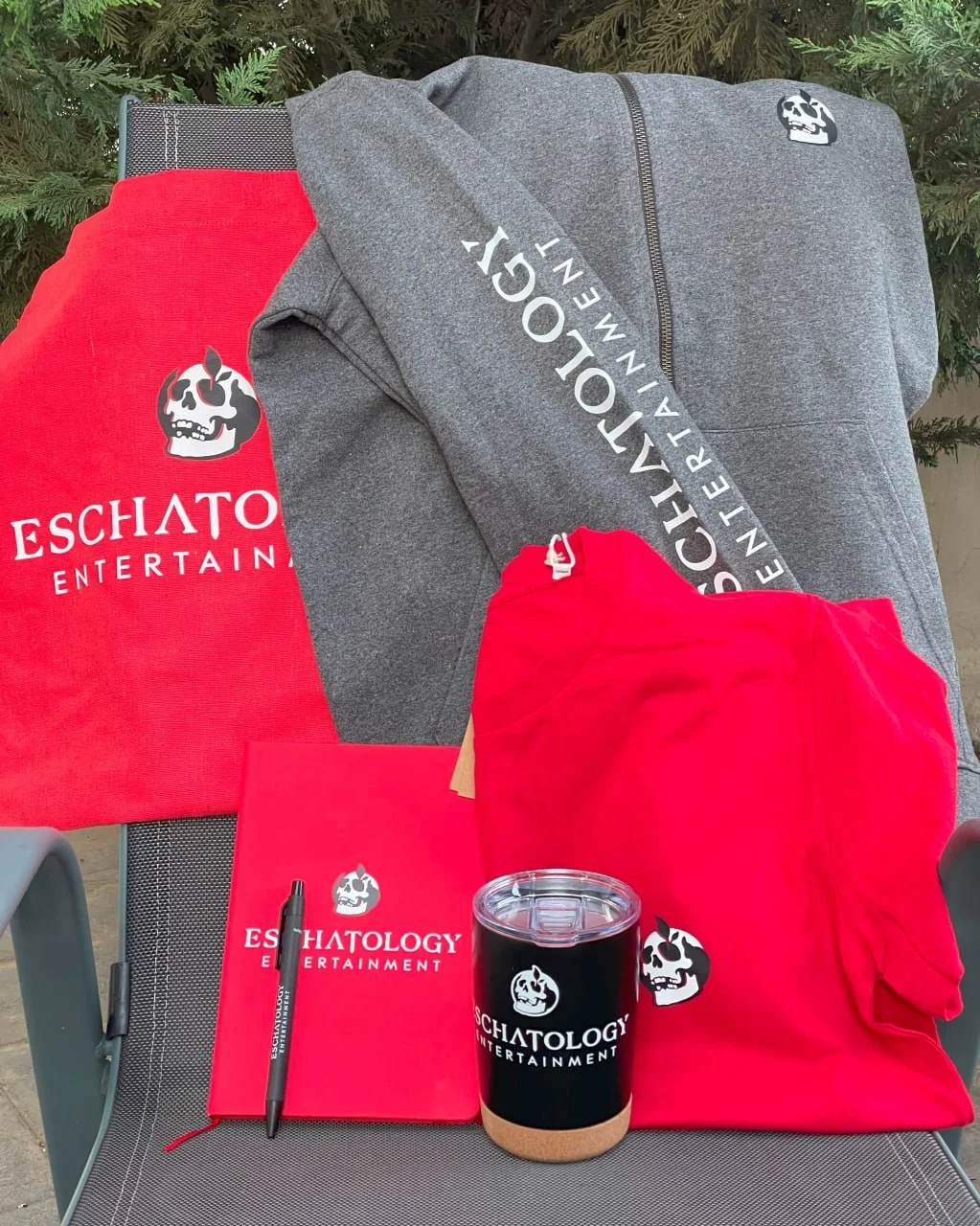 Eschatology Entertainment branded hoodie, T-shirt, notebook, pen and drinkware