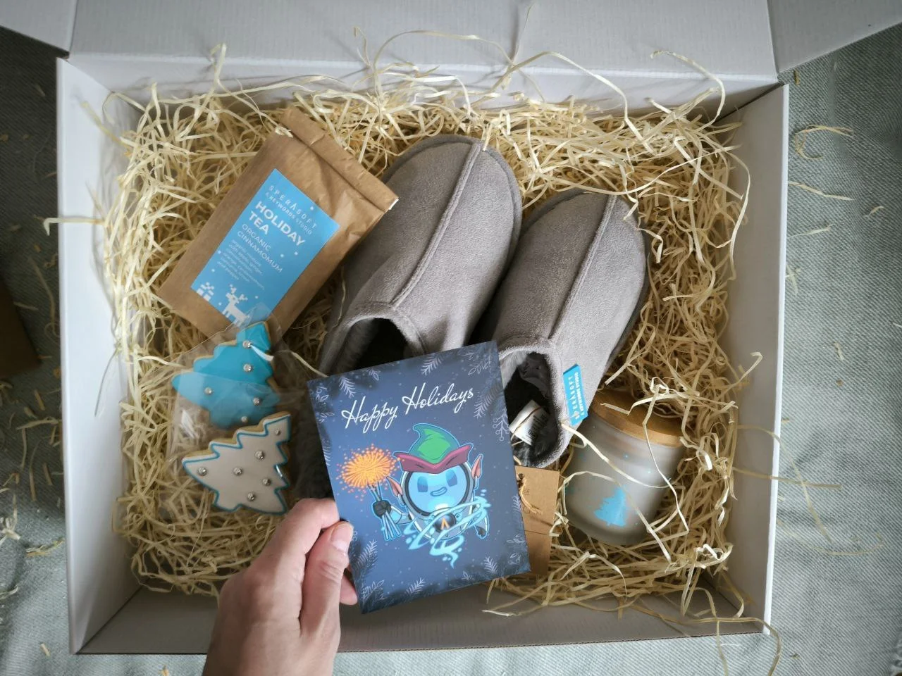 Holiday corporate gift box with slippers, drinkware, tea and a greeting card