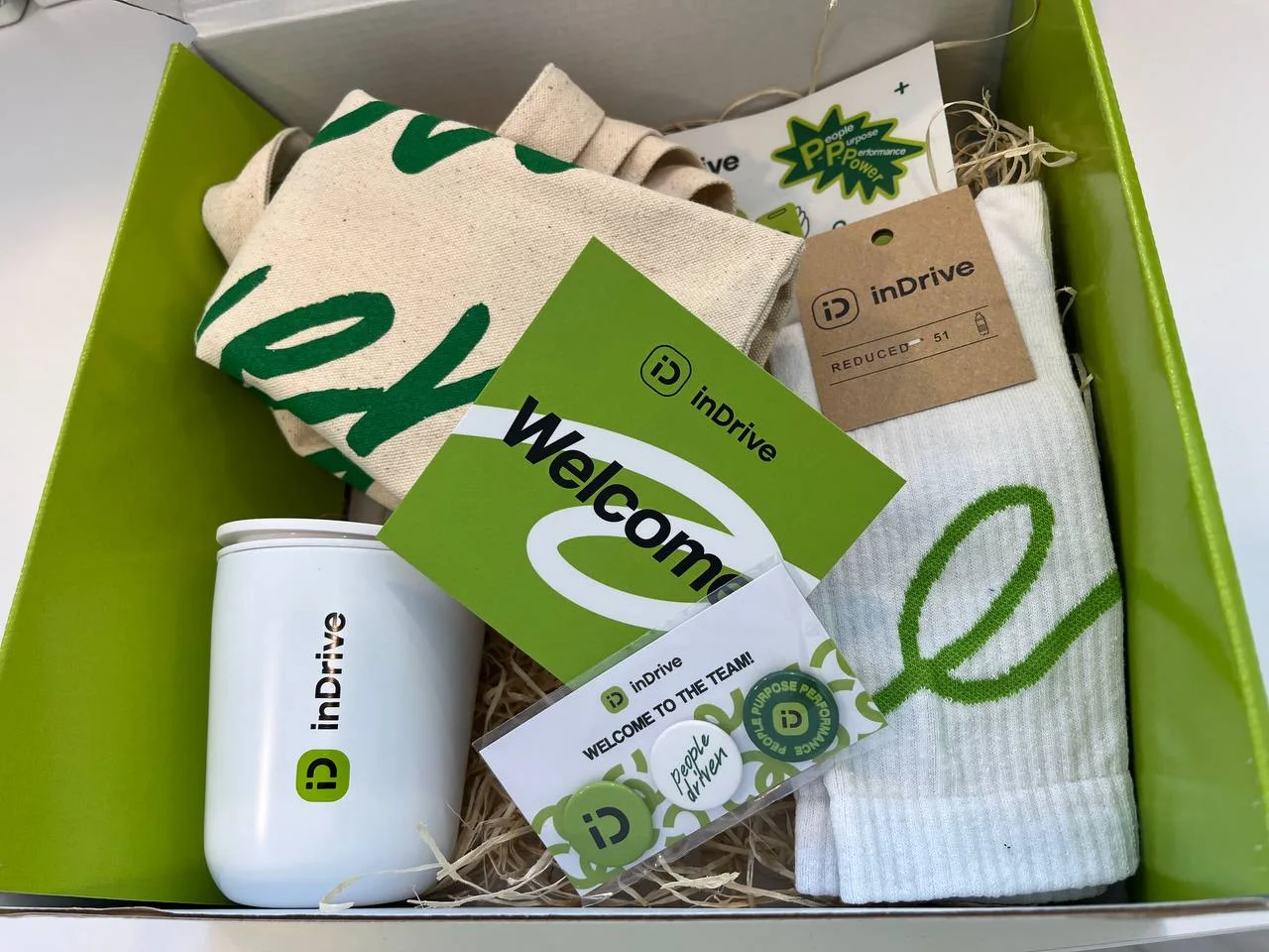 inDrive branded employee welcome kit with textile, drinkware and printed materials